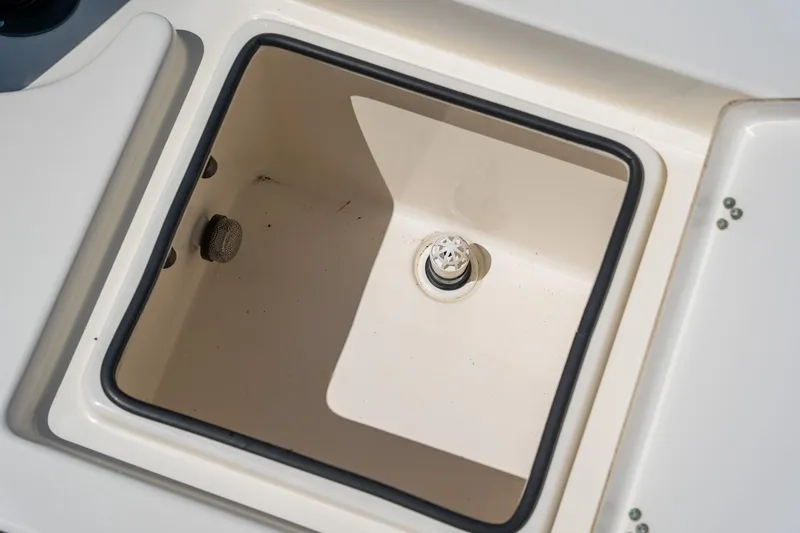 Slide: The Image of 2018 Pathfinder 2400 TRS boat storage compartment with drain plug. - 52