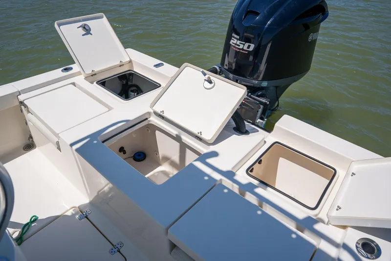 Slide: The Image of 2018 Pathfinder 2400 TRS boat with open storage compartments and Yamaha 250 engine. - 53