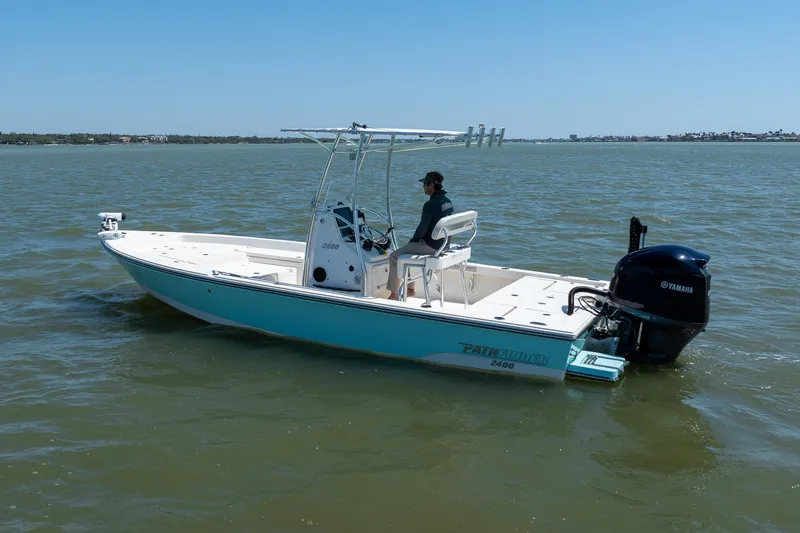 Slide: The Image of 2018 Pathfinder 2400 TRS boat on water with Yamaha engine, clear sky background. - 7