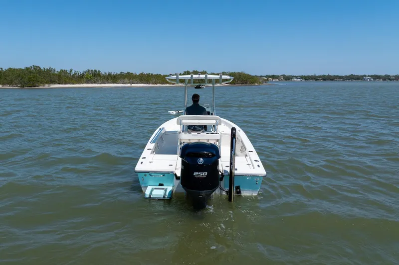 Slide: The Image of 2018 Pathfinder 2400 TRS boat on water, rear view with outboard motor. - 8