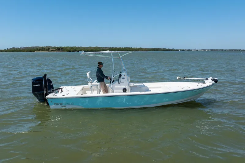 Slide: The Image of 2018 Pathfinder 2400 TRS boat on water, with Yamaha outboard motor, under clear blue sky. - 9