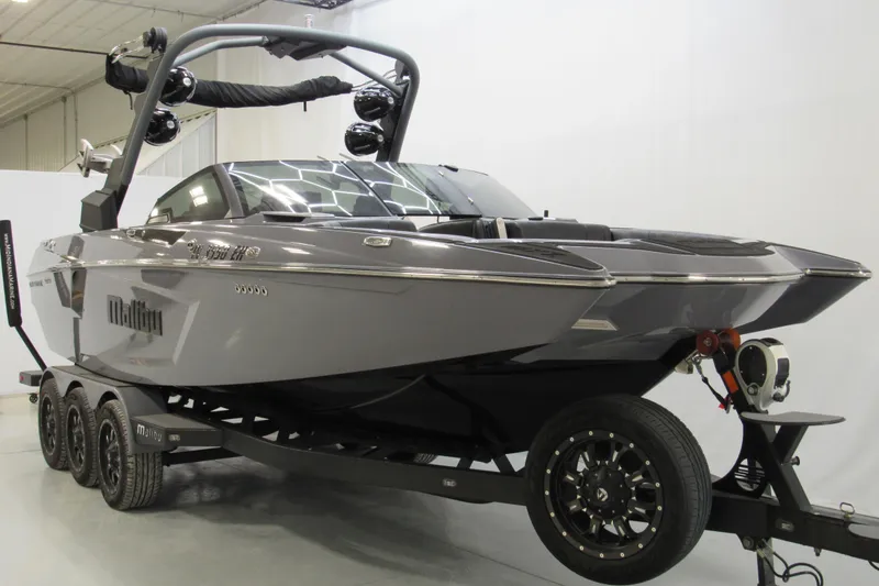 Slide: The Image of 2021 Malibu Wakesetter 24 MXZ boat on trailer in showroom. - 1