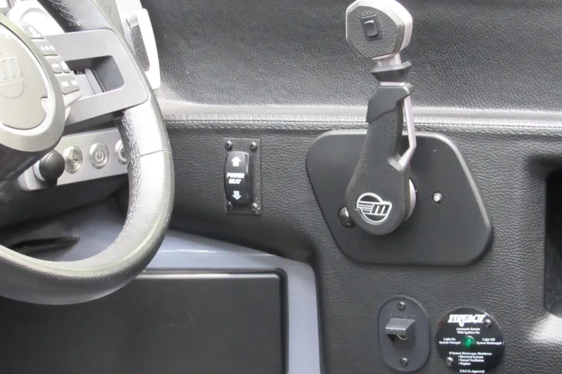 Slide: The Image of 2021 Malibu Wakesetter 24 MXZ steering wheel and control panel close-up. - 13