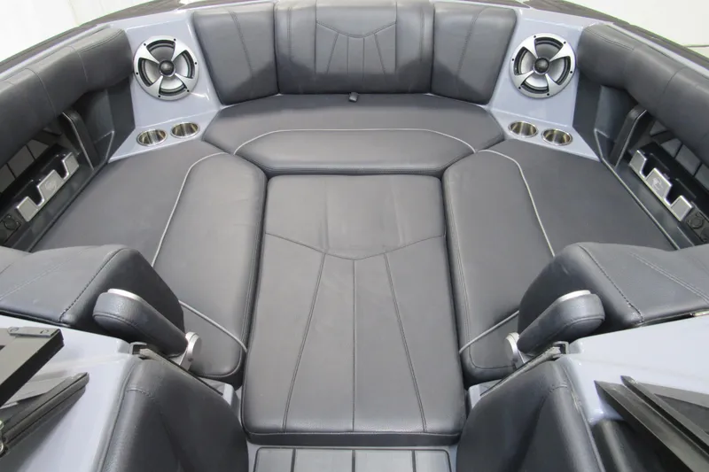 Slide: The Image of 2021 Malibu Wakesetter 24 MXZ interior with black leather seating and built-in speakers. - 14