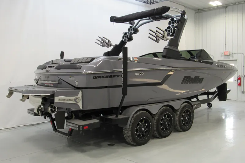 Slide: The Image of 2021 Malibu Wakesetter 24 MXZ boat on trailer in indoor showroom. - 2