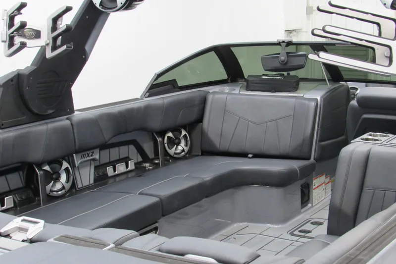 Slide: The Image of 2021 Malibu Wakesetter 24 MXZ interior with sleek gray seating and modern design. - 7