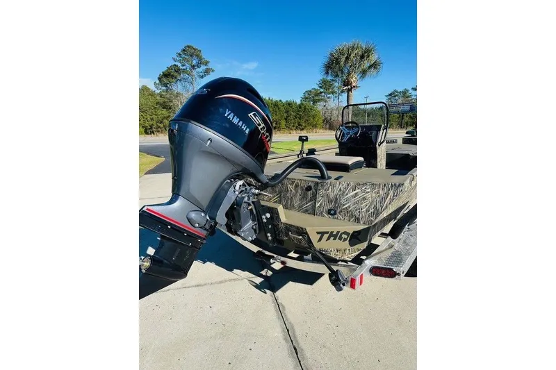 Slide: The Image of 2026 Thor 1900 boat with Yamaha outboard motor on a trailer, outdoors. - 4