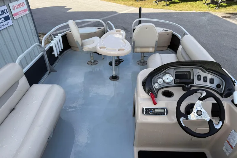 Slide: The Image of 2015 Sun Tracker Fishin' Barge 20 DLX interior with seating, steering console, and table. - 11