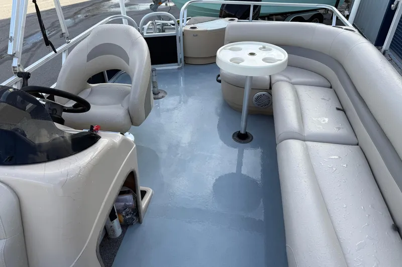 Slide: The Image of 2015 Sun Tracker Fishin' Barge 20 DLX interior with seating and steering console. - 14