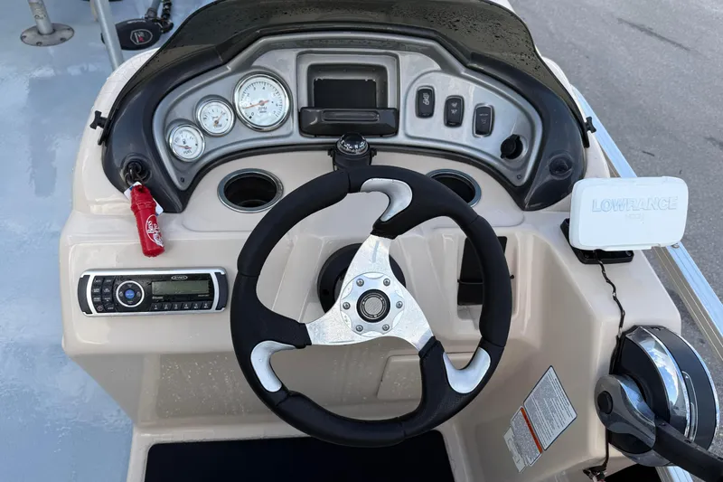 Slide: The Image of Dashboard of a 2015 Sun Tracker Fishin' Barge 20 DLX with steering wheel and gauges. - 16