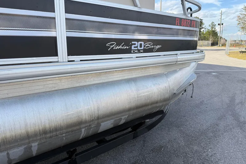 Slide: The Image of 2015 Sun Tracker Fishin' Barge 20 DLX pontoon boat, side view, parked on pavement. - 2