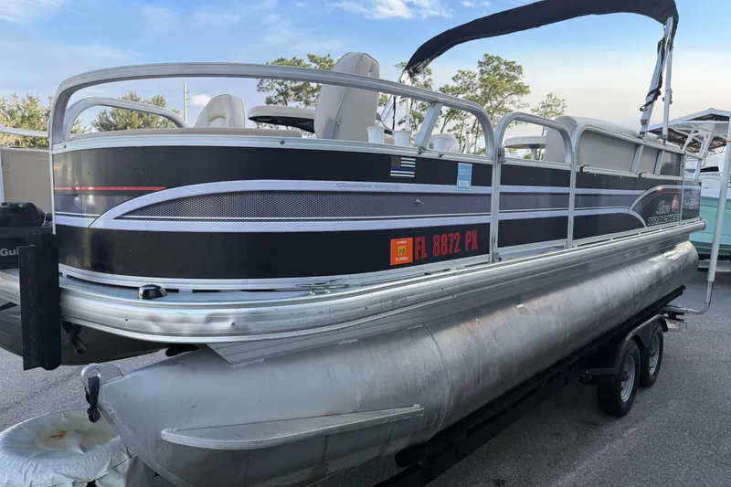 Slide: The Image of 2015 Sun Tracker Fishin' Barge 20 DLX pontoon boat on trailer, side view. - 4