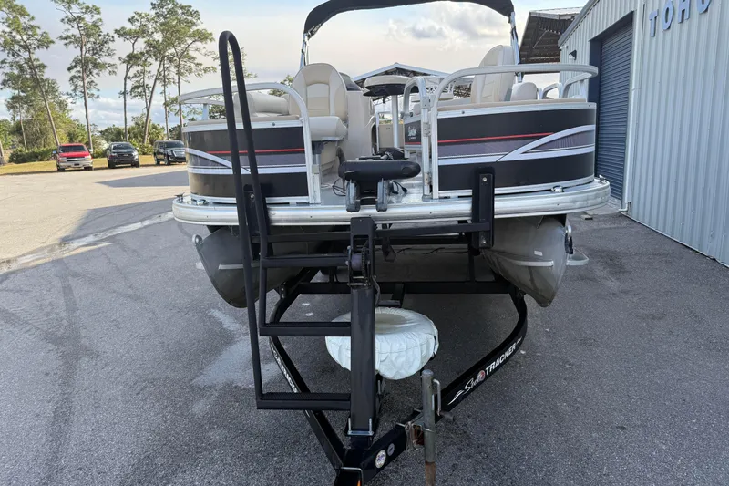 Slide: The Image of 2015 Sun Tracker Fishin' Barge 20 DLX on trailer, parked outdoors. - 5