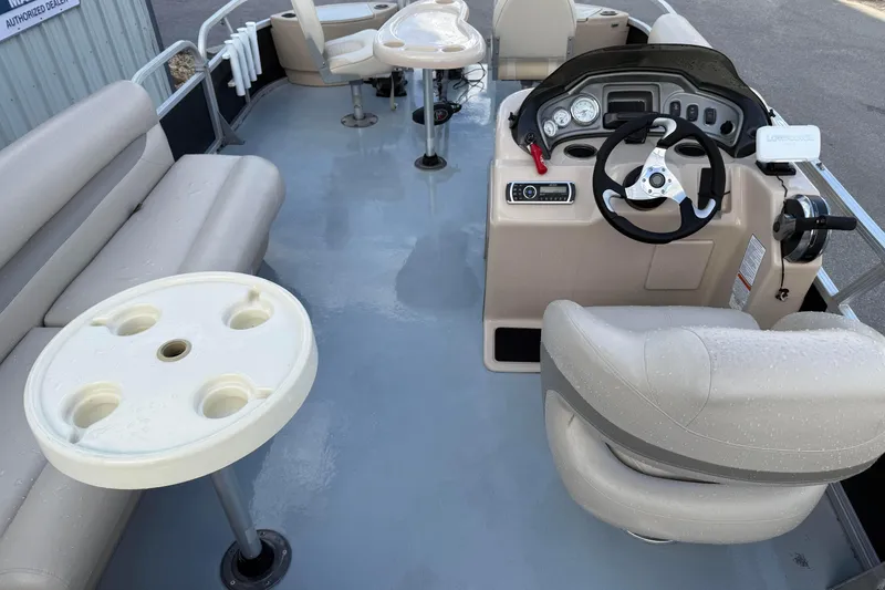 Slide: The Image of 2015 Sun Tracker Fishin' Barge 20 DLX interior with seating and steering console. - 9