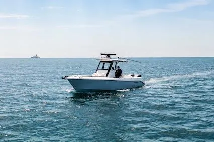 Slide: The Image of 2021 Everglades 295 Center Console boat cruising on open sea under clear sky. - 60