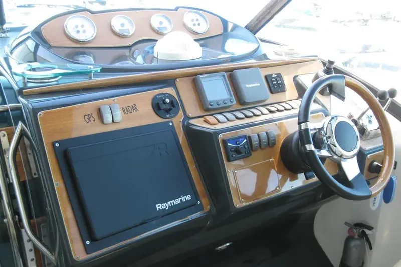 Slide: The Image of Control panel of a 2008 Doral Alegria boat with throttle and joystick. - 31