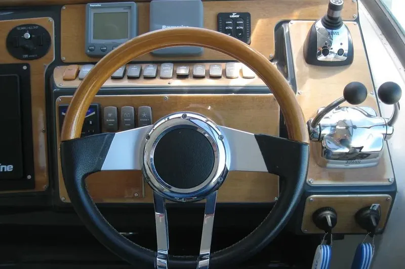 Slide: The Image of Control panel of 2008 Doral Alegria boat with EVC and function switches. - 32