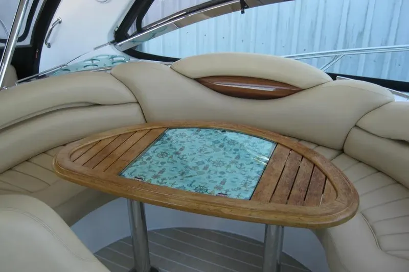 Slide: The Image of 2008 Doral Alegria yacht interior with curved seating, wooden table, and mounted TV. - 42