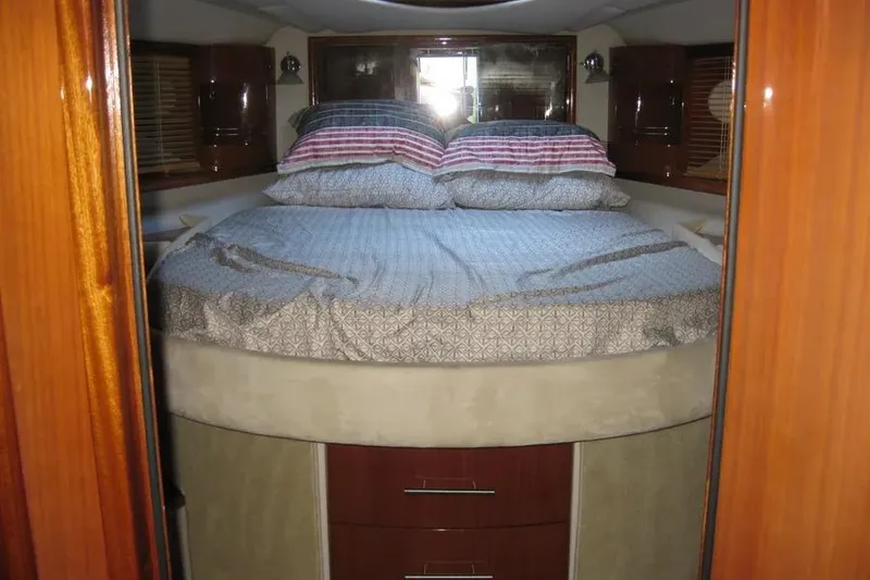 Slide: The Image of Interior of 2008 Doral Alegria yacht with bed, wooden cabinets, and blinds. - 64