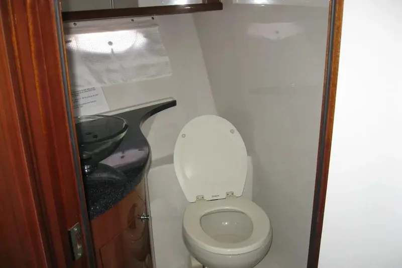 Slide: The Image of Shower area inside 2008 Doral Alegria boat with chrome fixtures and wooden trim. - 68