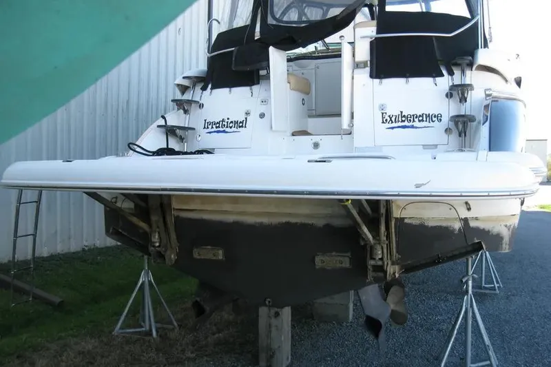 Slide: The Image of 2008 Doral Alegria boat propeller and rudder on gravel surface. - 8