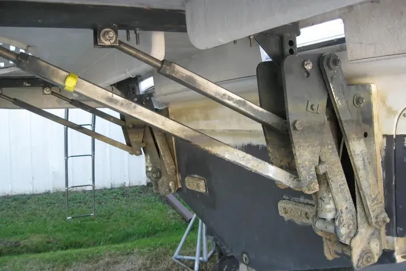 Slide: The Image of 2008 Doral Alegria boat propeller and rudder, displayed on dry land. - 9