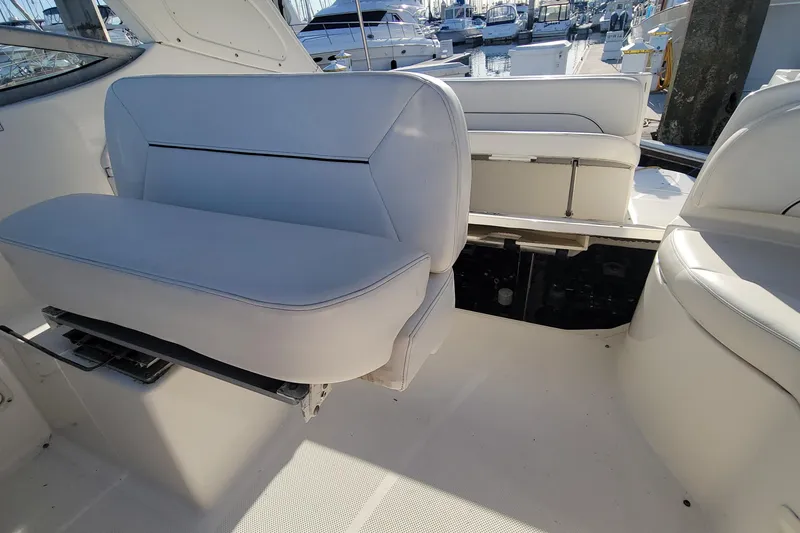 Slide: The Image of 2011 Bayliner 315 Cruiser interior seating with marina view. - 16
