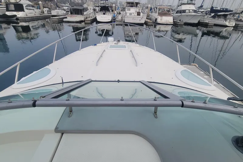 Slide: The Image of 2011 Bayliner 315 Cruiser docked at marina, surrounded by other boats. - 18