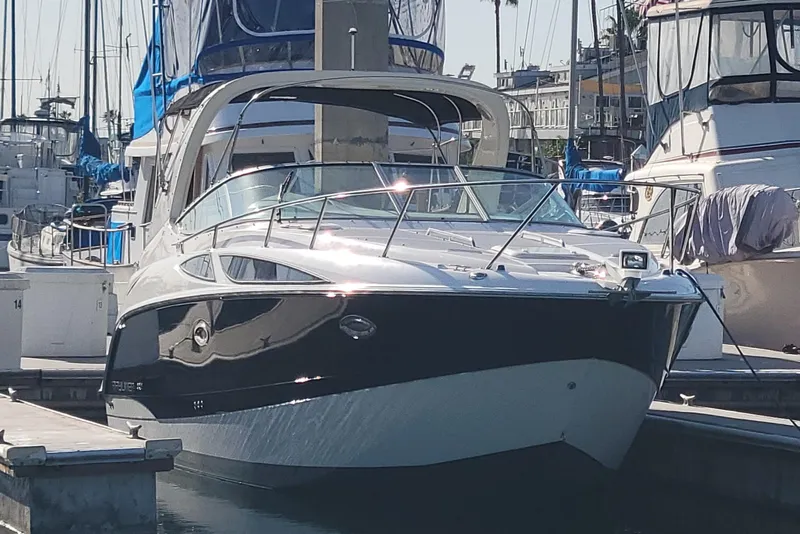Slide: The Image of 2011 Bayliner 315 Cruiser docked at marina, sleek design, sunny day. - 2