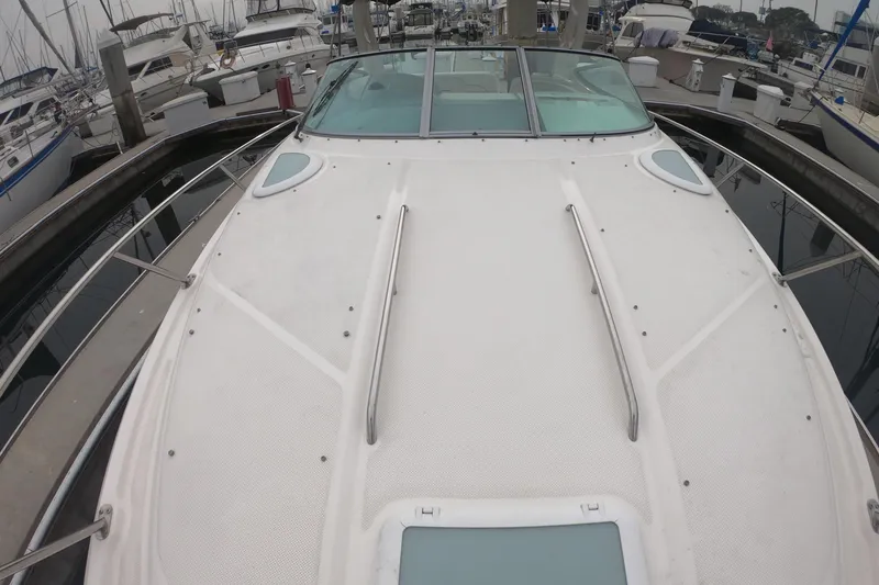 Slide: The Image of 2011 Bayliner 315 Cruiser boat docked at marina, view of deck and surrounding vessels. - 20