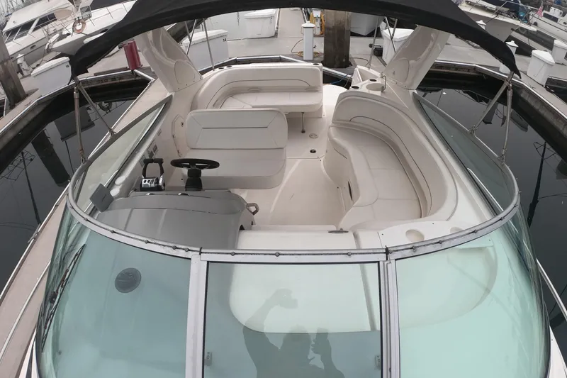 Slide: The Image of 2011 Bayliner 315 Cruiser interior with seating and helm, docked at marina. - 21