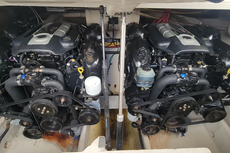 Slide: The Image of Twin engines of a 2011 Bayliner 315 Cruiser boat, showcasing detailed mechanics. - 24
