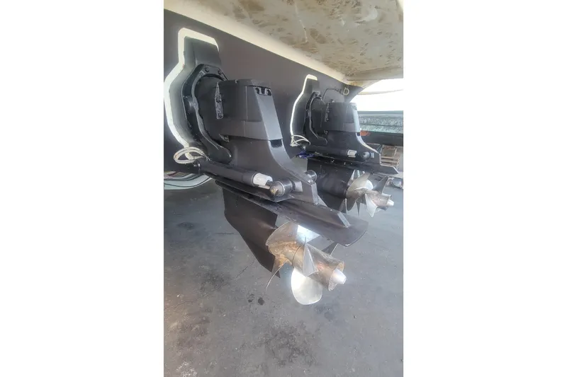 Slide: The Image of 2011 Bayliner 315 Cruiser dual propellers, close-up view of the stern drive system. - 26
