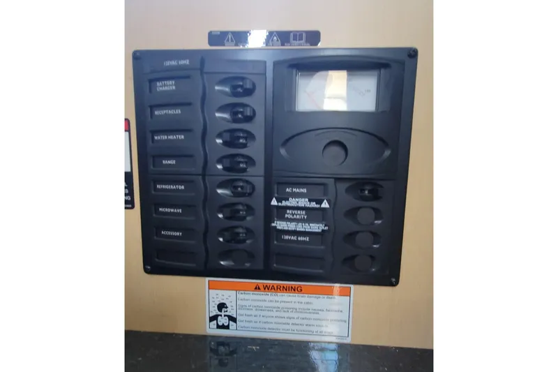 Slide: The Image of Control panel of a 2011 Bayliner 315 Cruiser with various switches and warning label. - 38