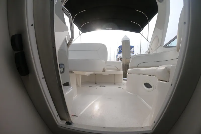 Slide: The Image of 2011 Bayliner 315 Cruiser interior with seating and canopy, docked at marina. - 40
