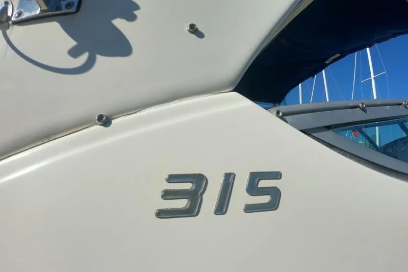Slide: The Image of 2011 Bayliner 315 Cruiser boat exterior with model number visible. - 41