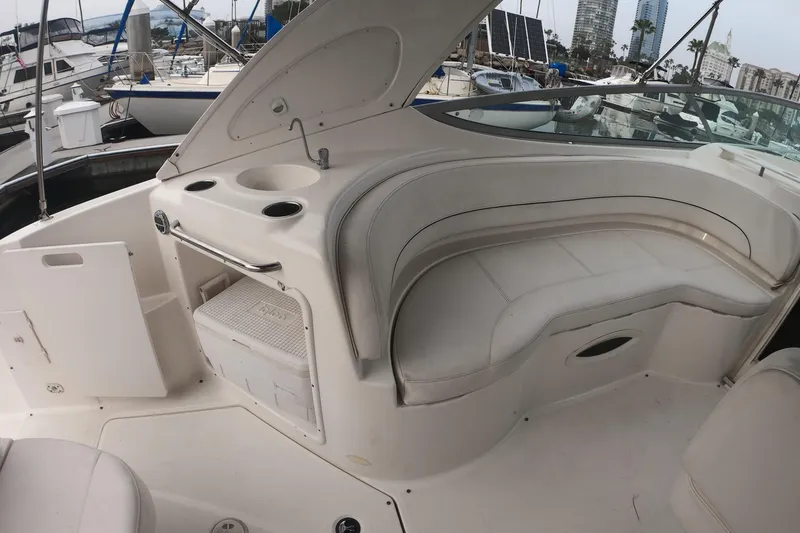 Slide: The Image of 2011 Bayliner 315 Cruiser interior with seating and storage, docked at marina. - 9
