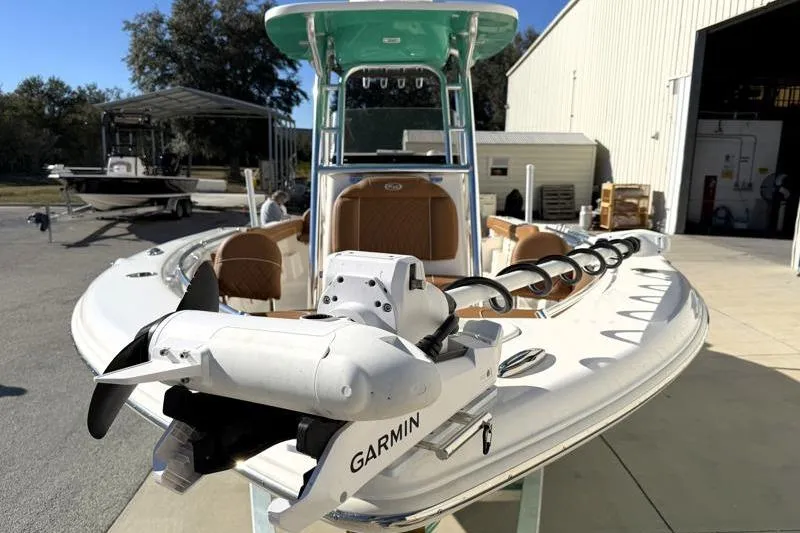 Slide: The Image of 2025 Key West 239 FS boat with Garmin equipment, docked near a warehouse. - 11