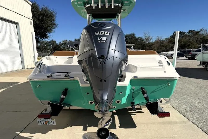 Slide: The Image of 2025 Key West 239 FS boat with 300 V6 engine, parked outdoors. - 12