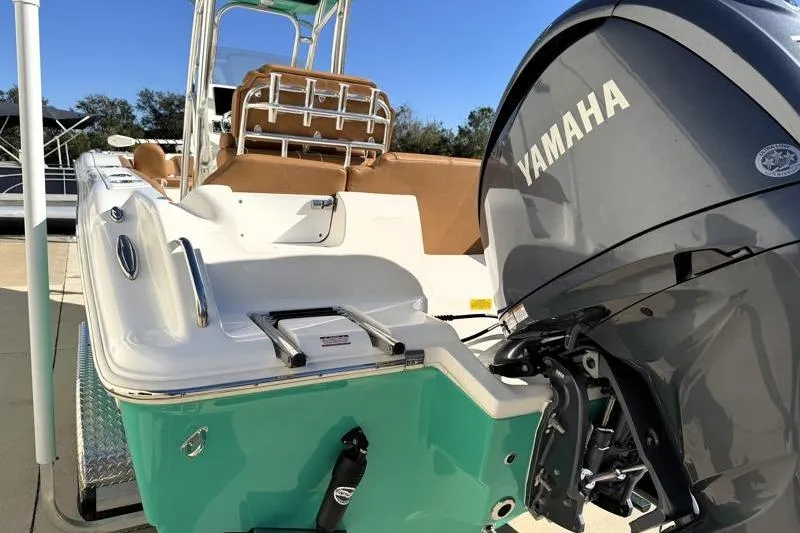 Slide: The Image of 2025 Key West 239 FS boat with Yamaha engine, teal and white design. - 13