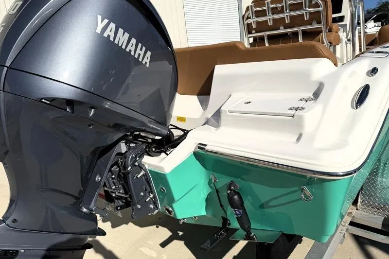 Slide: The Image of 2025 Key West 239 FS boat with Yamaha outboard motor, teal and white design. - 14