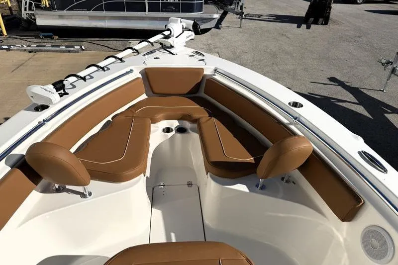 Slide: The Image of 2025 Key West 239 FS boat interior with brown cushioned seating and white deck. - 18