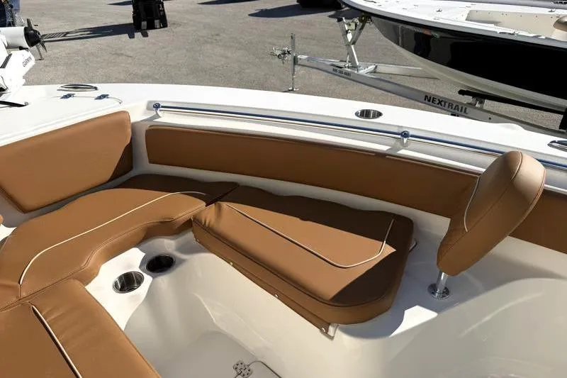 Slide: The Image of 2025 Key West 239 FS boat interior with tan cushioned seating and cup holders. - 20