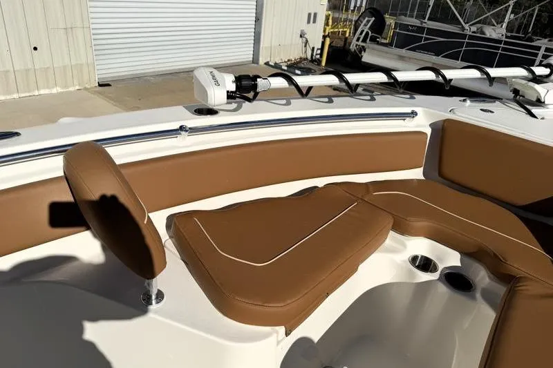 Slide: The Image of 2025 Key West 239 FS boat interior with brown seating and fishing equipment. - 21