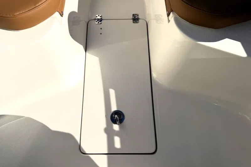 Slide: The Image of 2025 Key West 239 FS boat deck with storage compartment and brown seating. - 22