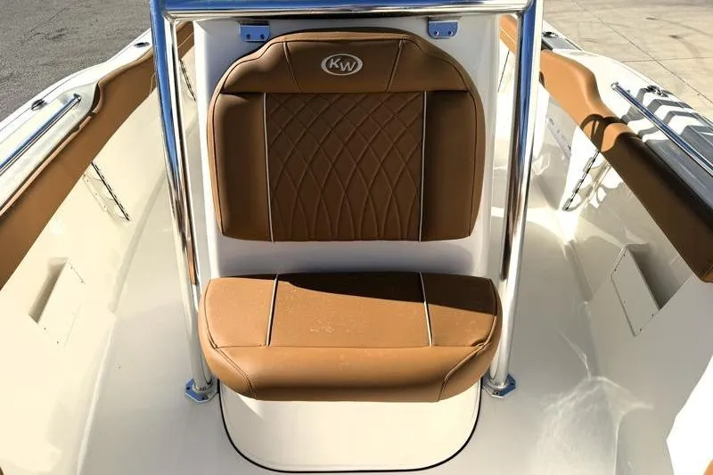 Slide: The Image of 2025 Key West 239 FS boat seat with brown leather upholstery and chrome accents. - 23