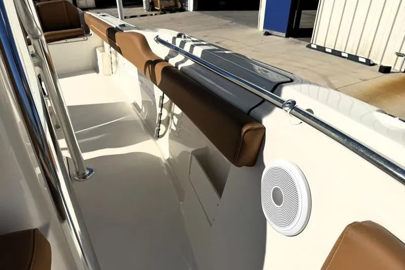Slide: The Image of 2025 Key West 239 FS boat interior with brown seating and speaker. - 26