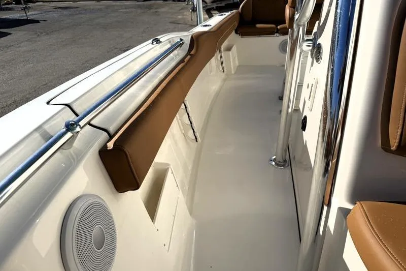 Slide: The Image of 2025 Key West 239 FS boat interior with brown seating and stainless steel railings. - 27