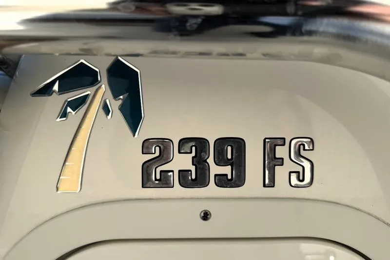 Slide: The Image of Key West 239 FS 2025 model logo with palm tree design on boat exterior. - 28