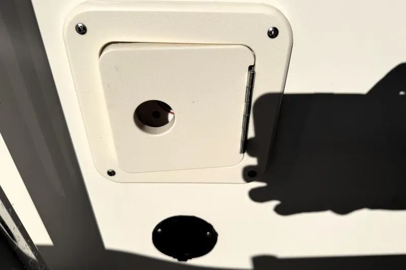 Slide: The Image of Access panel on 2025 Key West 239 FS boat, featuring a small circular opening. - 32